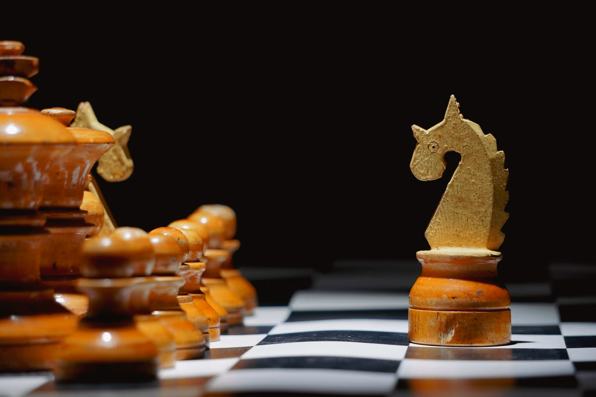 Chess pieces arranged on a dark board, representing financial strategy