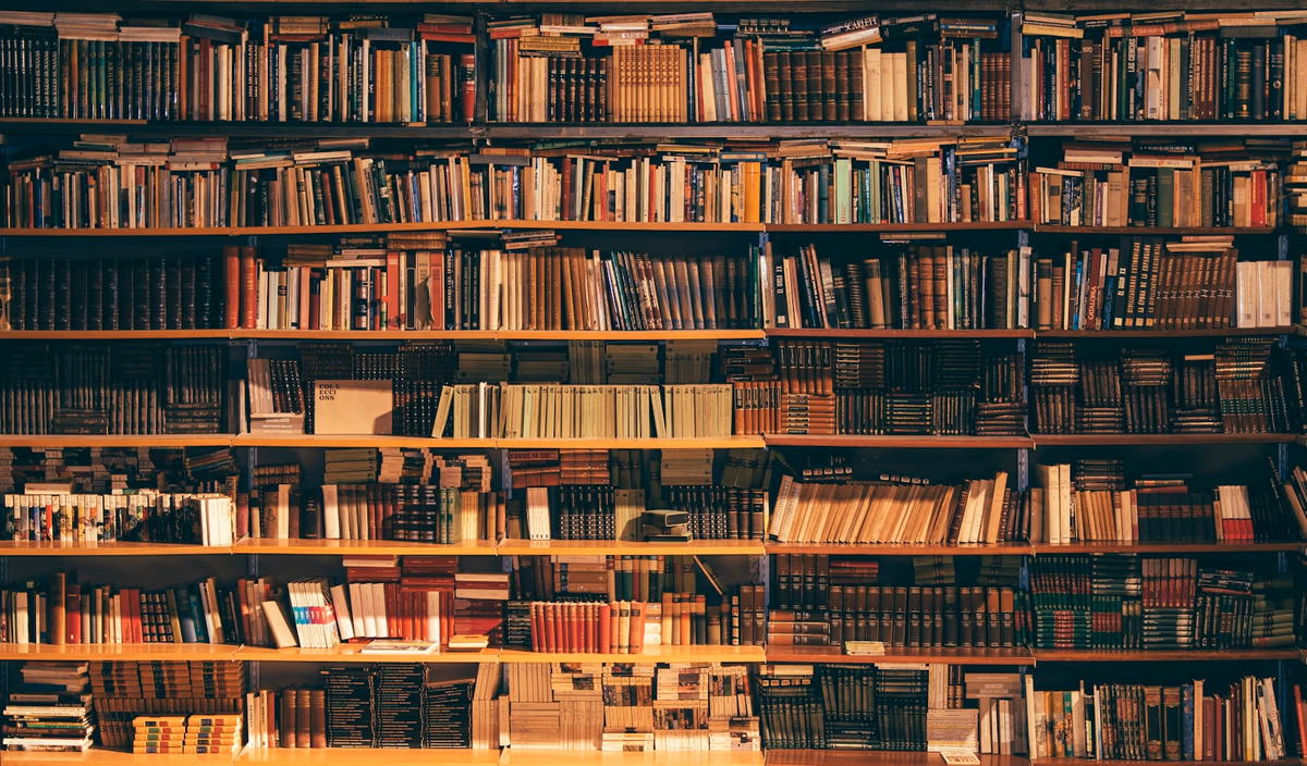 Stack of academic journals and open research papers on a desk