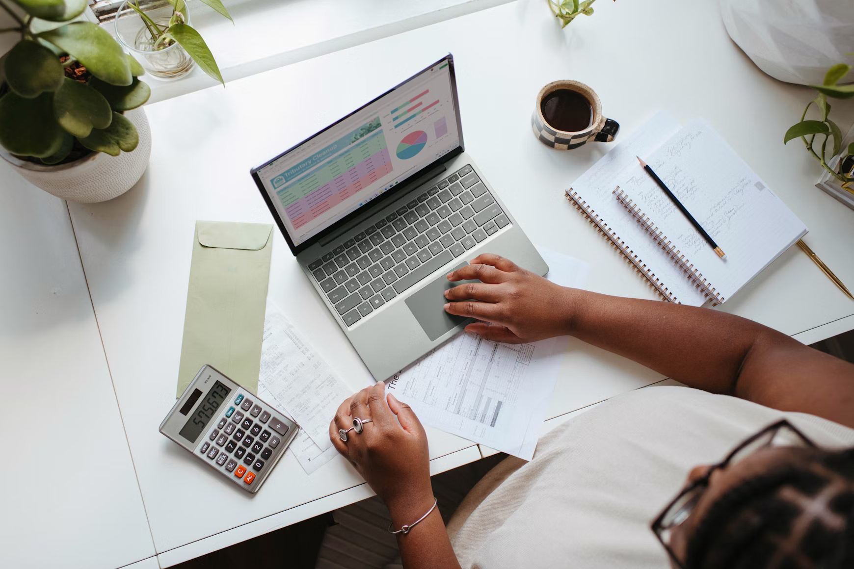 Person organizing financial documents and planning debt payoff