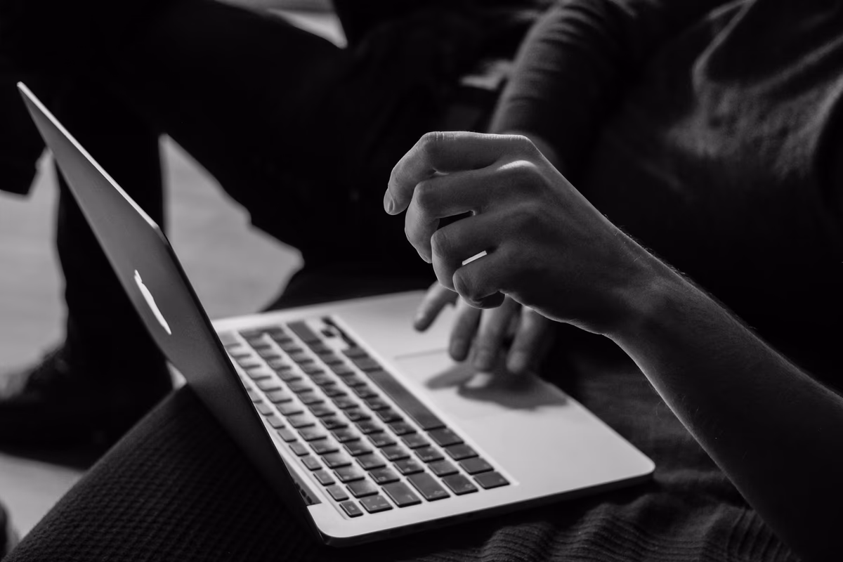Minimal wooden desk with an open laptop — a clean workspace for setting up a new budgeting app after leaving Mint