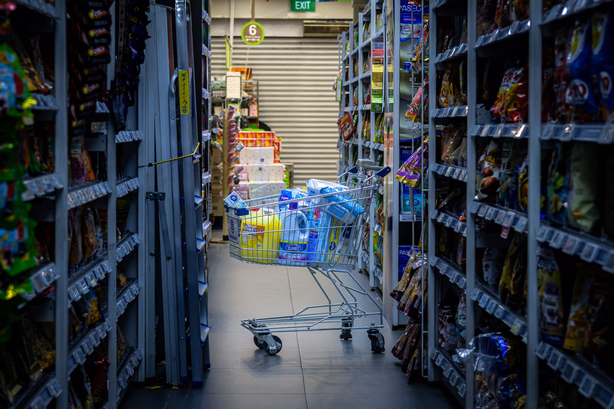 A shopping cart in a grocery store aisle