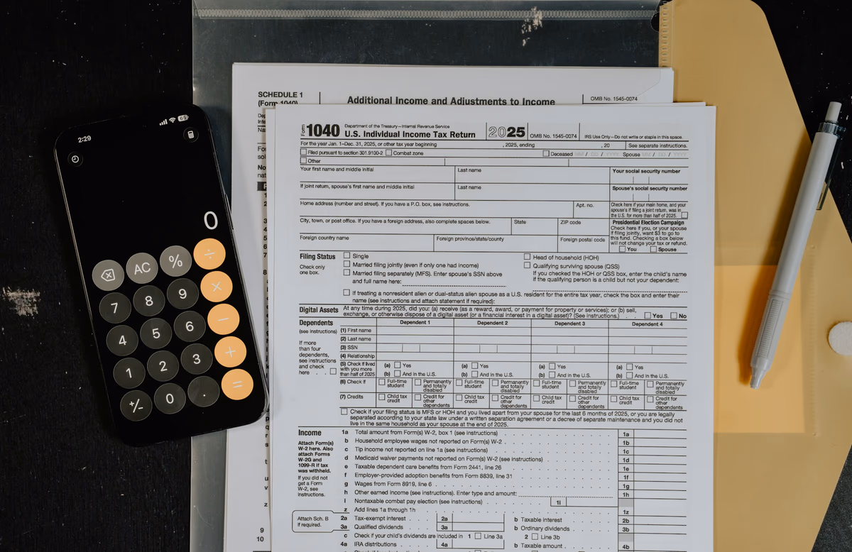 Tax forms and a calculator on a clean desk, ready for filing